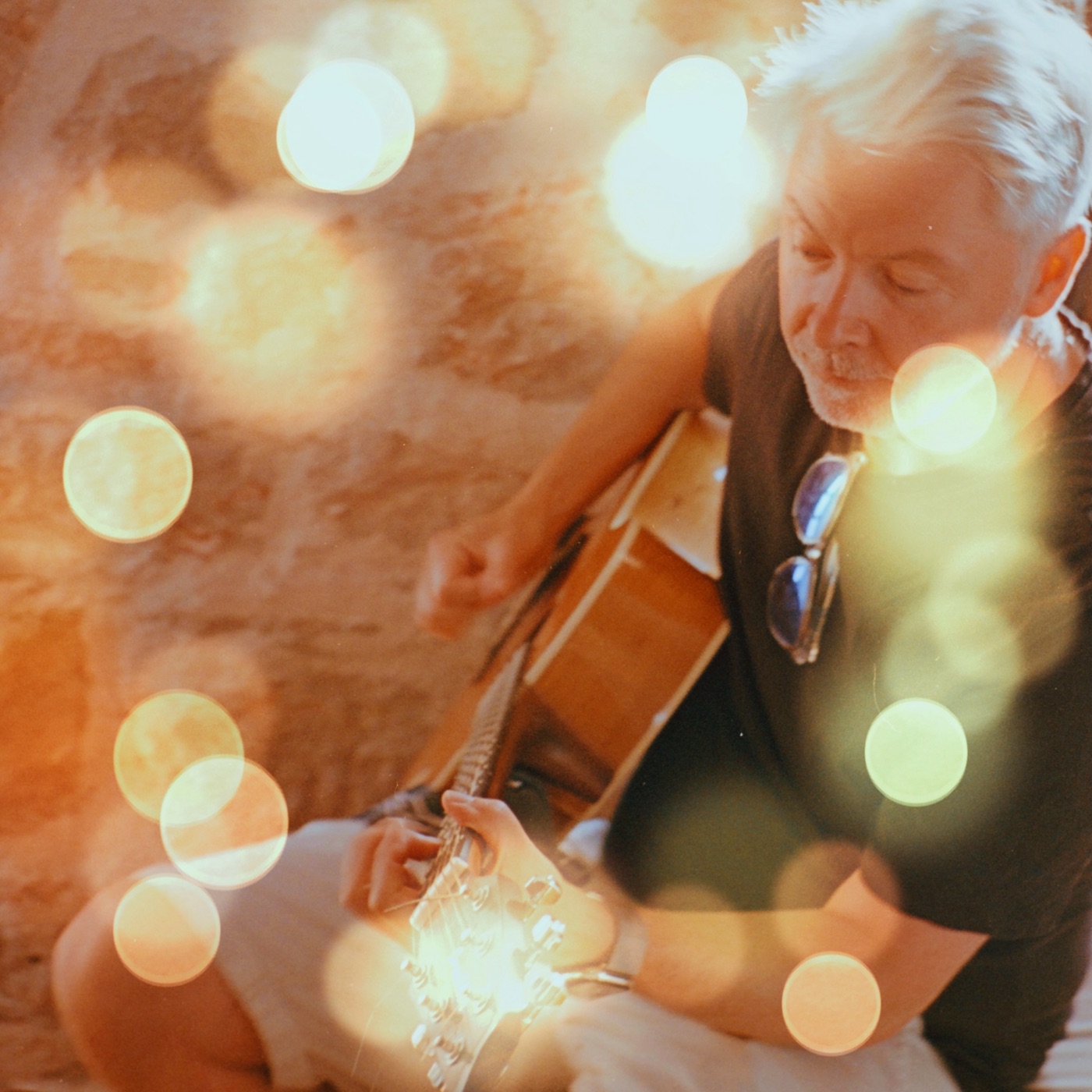 Tobin Harris playing acoustic guitar